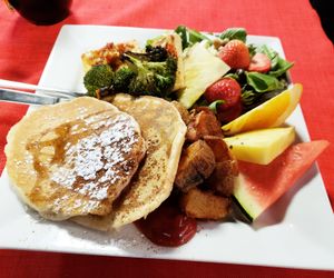 Vegan Supreme...with pancakes, home fries, pesto tofu, roasted vegetables, salad, and fresh fruit. at Karine's in Toronto