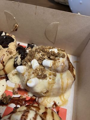 Orange Creamsicle Cinnamon Roll (Orange Cream Frosting, Pie Crust Crumbles, Marshmallows, and Caramel Sauce)  at Cinnaholic  in Cary