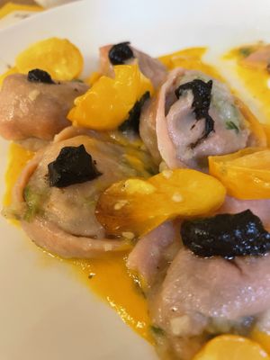 Vegan filled pasta with cabbage and potatoes served with yellow tomato sauce and black garlic   at Sfoglia Rina in Bologna