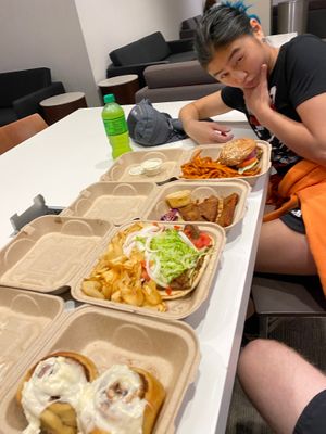 Cinnamon rolls, gyro, thai chili wings, and spicy crispy chicken sandwich at The Chicago Diner - Lakeview in Chicago