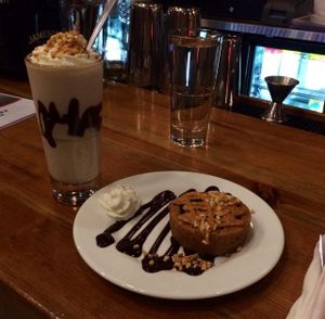 peanut butter 'puck' with chocolate sauce and whipped cream & peanut butter chocolate chip milkshake at The Chicago Diner - Lakeview in Chicago