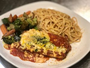 Vegan chicken Parmesan made from seasoned and spiced grilled tofu , vegan cheese and tomato Sauce paired with spaghetti in our creamy coconut Rose sauce  at Paliottis Westside in Maple Ridge