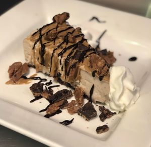 Chocolate peanut butter cheesecake with homemade vegan PB chocolate pieces and sauces made completely vegan & also is gluten friendly  at Paliottis Westside in Maple Ridge