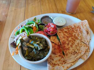 The special that day: crumbled veggie ground quesadilla with pico de gallo and avocado crema. Served with a side salad and collard greens. at Sluggo's North Vegetarian Cafe in Chattanooga