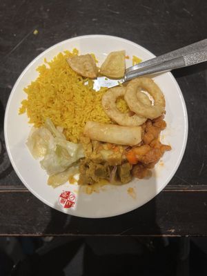 Platter of fried rice, crispy potatoes, onion rings, sweet & sour chicken, mixed vegetables and chicken curry at Su Vegan Buffet in West London