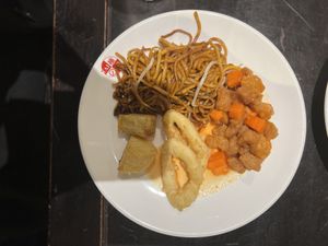 Platter or noodles, sweet & sour chicken, onion rings, crispy potatoes and chilli sauce at Su Vegan Buffet in West London