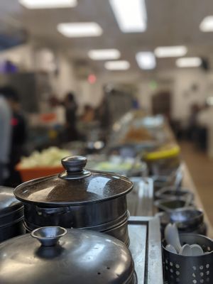 Long, long line of vegan dishes with a lovely depth of field so you can't see any of them! at Su Vegan Buffet in West London