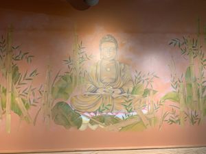 Large Buddha painting on wall  at Green Lotus in San Jose