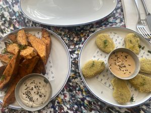 Massive portion of sweet potatoes and side of nuggets  at Flax & Kale in Madrid