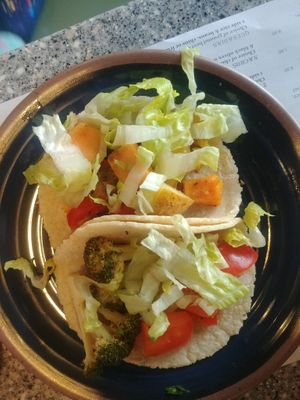 Broccoli adobo and patatas at Migrants in Madison