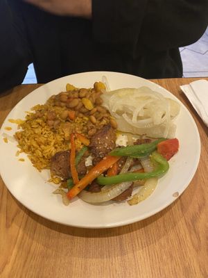 Yuca, yellow rice with read beans. “Pepper steak”  at The Earthy Kitchen in Orlando