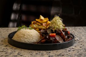 Vega lomo saltado de la casa con papas fritas y arroz at Lounge del Brujo Vegan Kitchen & Bar Cayma in Arequipa