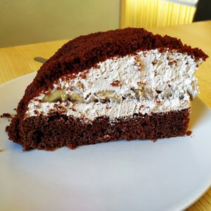 Cocoa cake with coconut cream and banana. Absolutely delicious! at Loving Hut - Na Porici in Prague
