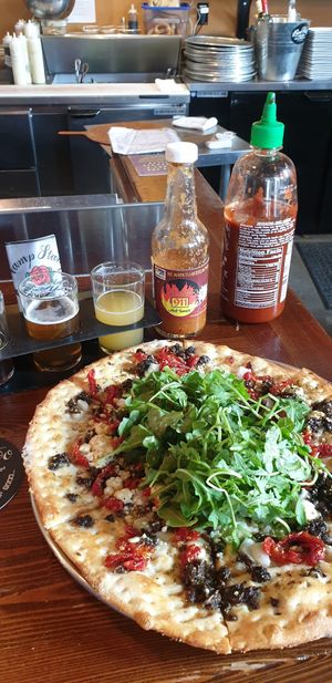 Vegan pizza and beer tasting plate at Bad Tattoo Brewing in Penticton