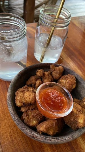 Cauliflower wings (vegan & super good) and coconut water with ice  at Moochie's Cafe in Weligama