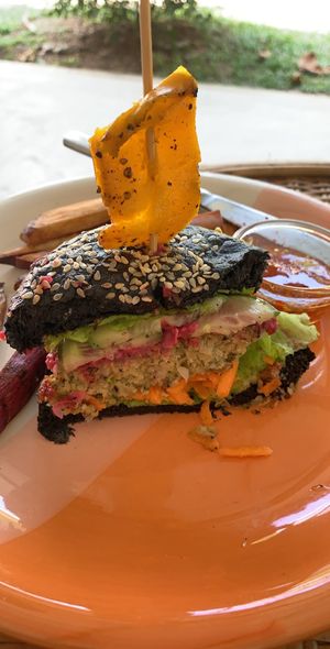 Vegan burger inside! Charcoal bun, it is not burnt!  at Moochie's Cafe in Weligama