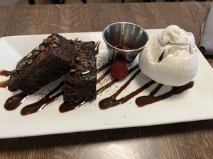 Warm brownie drizzled with fudge served with vanilla gelato on the side! Absolutely amazing! Melts in your mouth!  at Spirit Elephant in Winnetka
