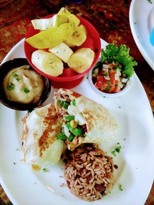 Vegan burrito, hummus, fruit cup at Simon Says  in San Juan Del Sur
