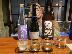 Monkey-san posing with a flight of sake  at Veganic Monkey Magic 浅草 in Tokyo