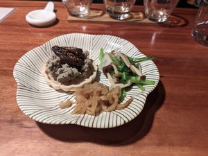 Mushroom paste on rice crackers, radish pickle, enoki and greens at Veganic Monkey Magic 浅草 in Tokyo
