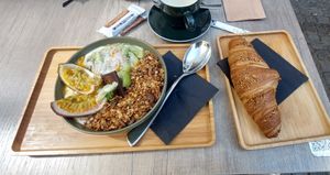 Soya yoghurt bowl with granola, kiwi and passionfruit + vegan croissant at Kaffee Kamiel in Bruges