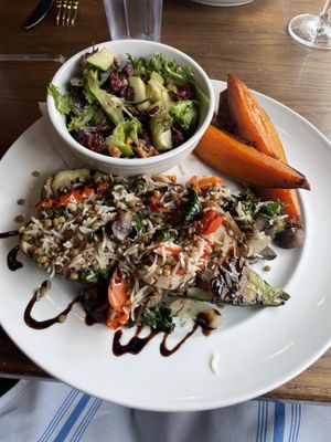 Stuffed zucchini - comes with the side salad. Our server said that the sweet potato wedge side is vegan without the honey sauce so I ordered those as well.   at Harvest 18 in Durham