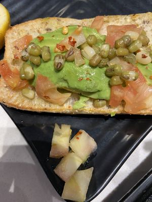 White tomato pieces that shouldn’t have been in the avocado toast   at Copper Branch - Argentia Rd in Mississauga