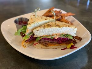 Corned Seitan Rueben - Grilled corned seitan, fermented sauerkraut, vegan Swiss cheese, arugula and Russian dressing on grilled carraway focaccia bread.  at The Panacea Restaurant in Wilmington
