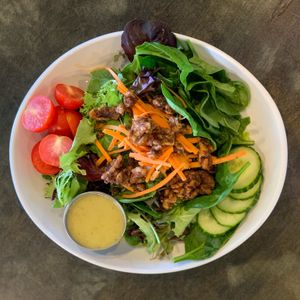 Panacea House Salad - Spring mix, cucumber, tomato, carrot, tossed walnuts and micro greens with your choice of dressing.  at The Panacea Restaurant in Wilmington