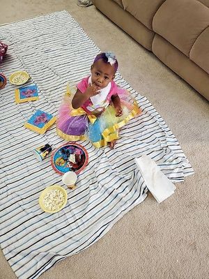 One happy birthday girl is enjoying her donuts. at Rejoice in Geneva