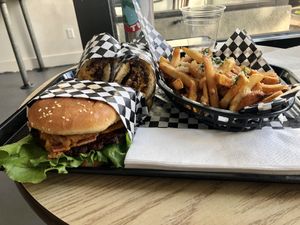 Burger with onion rings and bacon 😋, philly cheezesteak, and stadium fries with ‘Parmesan ’ 🤤 yum.   at Malibu's Burgers in Oakland