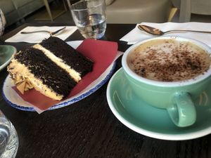 Salted caramel fudge cake and oat cappuccino   at Wulf & Lamb Marylebone in London