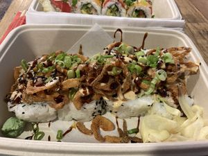 Super Saiyan Roll - house imitation crab meat, avocado, and cucumber. Topped with crispy onions, spicy mayo, Naughty Glaze, green onions and sesame seeds. at Naughty Panda in Santa Ana