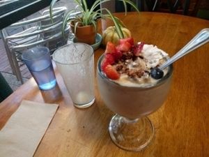 filtered water cup, empty tropical smoothie, and sunshine bowl at Bliss Cafe in San Luis Obispo