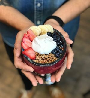 Vibrant Tropical Bliss Smoothie Bowl - topped with fruit, house made gluten-free granola and coconut whipped cream! at Bliss Cafe in San Luis Obispo