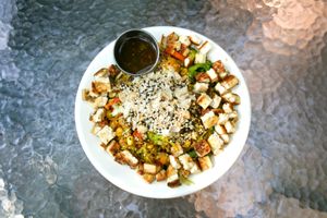 Broccoli ginger sesame bowl -Sautéed tofu, broccoli, zucchini, garbanzo beans, cabbage, carrots, red bell pepper, and grilled corn topped with cilantro, roasted cashews, hemp seed at Bliss Cafe in San Luis Obispo