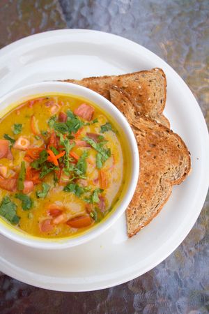 Vegan yellow lentil vegetable soup with a side of bread. at Bliss Cafe in San Luis Obispo