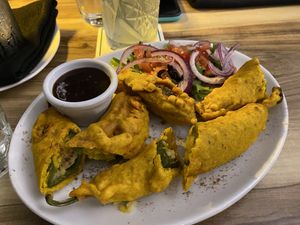 Green chillies, chickpea flour, stuffed with potato and spices   at Marinades Indian Cuisine in Cairns