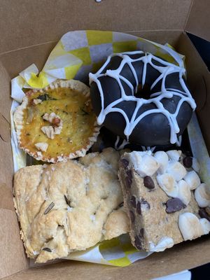 Artichoke and spinach quiche, chocolate spider donut, focaccia bread, s’mores bar  at Yellow Rose Vegan Bakery in Maplewood