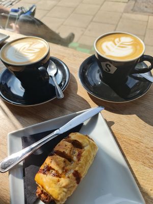 Oat lattes and vegan sausage roll at Strangers Coffee House in Norwich