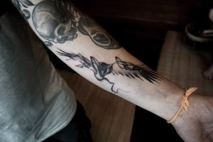 𝙄𝙂: 𝙣𝙖𝙩𝙚_𝙩𝙝𝙖𝙞𝙡𝙖𝙣𝙙 🌿 Ethereal blackwork raven tattoo on forearm at Baan Khagee Tattoo Chiang Mai, Thailand at Baan Khagee Tattoo in Chiang Mai