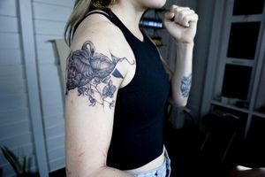 𝙄𝙂: 𝙣𝙖𝙩𝙚_𝙩𝙝𝙖𝙞𝙡𝙖𝙣𝙙 🌿 Blackwork abstract swan tattoo and orchid flowers by a blackwork tattoo artist in Chiang Mai, Thailand  at Baan Khagee Tattoo in Chiang Mai