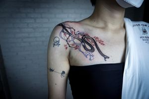 𝙄𝙂: 𝙣𝙖𝙩𝙚_𝙩𝙝𝙖𝙞𝙡𝙖𝙣𝙙 🌿Blackwork realistic snake tattoo with Sakura flowers and fine line wave by a tattoo artist in Chiang Mai, Thailand at Baan Khagee Tattoo in Chiang Mai