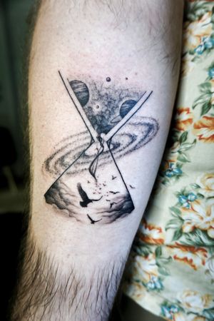 𝙄𝙂: 𝙣𝙖𝙩𝙚_𝙩𝙝𝙖𝙞𝙡𝙖𝙣𝙙 🌿 Fine line hourglass tattoo with galaxy and birds on forearm by a blackwork tattoo artist from Baan Khagee Tattoo Ch at Baan Khagee Tattoo in Chiang Mai
