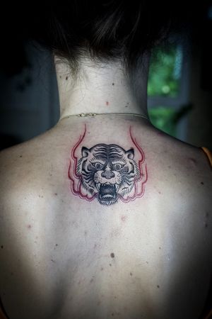 𝙄𝙂: 𝙣𝙖𝙩𝙚_𝙩𝙝𝙖𝙞𝙡𝙖𝙣𝙙 🌿 Blackwork traditional tiger tattoo with red flow by Baan Khagee Tattoo Chiang Mai, Thailand at Baan Khagee Tattoo in Chiang Mai