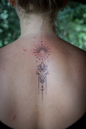 𝙄𝙂: 𝙣𝙖𝙩𝙚_𝙩𝙝𝙖𝙞𝙡𝙖𝙣𝙙 🌿 Fine line lotus and sun tattoo by Baan Khagee Tattoo Chiang Mai, Thailand at Baan Khagee Tattoo in Chiang Mai