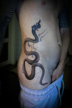𝙄𝙂: 𝙣𝙖𝙩𝙚_𝙩𝙝𝙖𝙞𝙡𝙖𝙣𝙙 🌿 Blackwork Thai Naga with blue flow by Thai blackwork tattoo artist in Chiang Mai, Thailand at Baan Khagee Tattoo in Chiang Mai