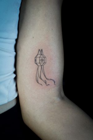 𝙄𝙂: 𝙣𝙖𝙩𝙚_𝙩𝙝𝙖𝙞𝙡𝙖𝙣𝙙 🌿 Fine line minimal lantern tattoo by a tattooist in Chiang Mai, Thailand  at Baan Khagee Tattoo in Chiang Mai