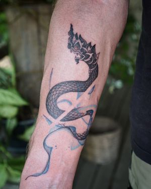 𝙄𝙂: 𝙣𝙖𝙩𝙚_𝙩𝙝𝙖𝙞𝙡𝙖𝙣𝙙 🍃 Thai Naga tattoo with abstract flow by Baan Khagee Tattoo Chiang Mai, Thailand at Baan Khagee Tattoo in Chiang Mai