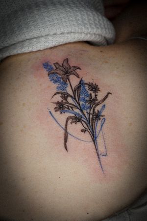 𝙄𝙂: 𝙣𝙖𝙩𝙚_𝙩𝙝𝙖𝙞𝙡𝙖𝙣𝙙 🍃 Flower bouquet tattoo with blue lavender by Baan Khagee Tattoo Chiang Mai, Thailand at Baan Khagee Tattoo in Chiang Mai